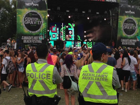 The boys in blue — or in this case neon green — look on during Wolfgang Gartner's set on Sunday. There was significant police presence throughout the concert grounds, ensuring everybody stayed safe in the fun environment. The next photo captures a female fan on the shoulders of a male friend in front of a giant screen as Wolfgang Gartner performs.