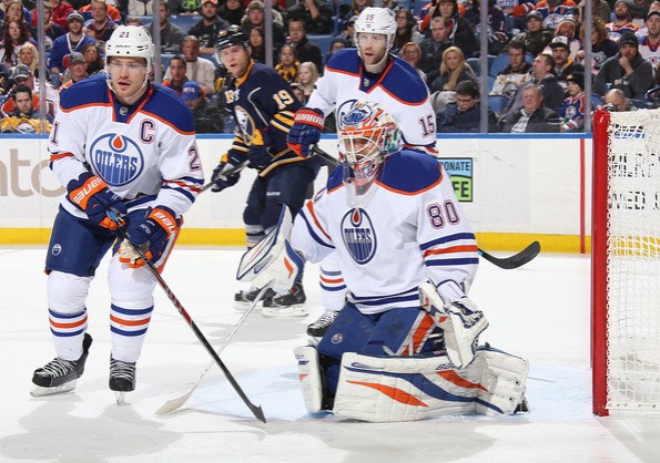 Sean Rudyk/Getty Images Edmonton Oilers goalie Ilya Bryzgalov braces for an incoming shot as teammates Andrew Ference, left, and Nick Schultz defend against Cody Hodgson and the Buffalo Sabres during NHL action in Buffalo on Monday. The Oilers won 3-2, thanks in large part to Bryzgalov's 42 saves.