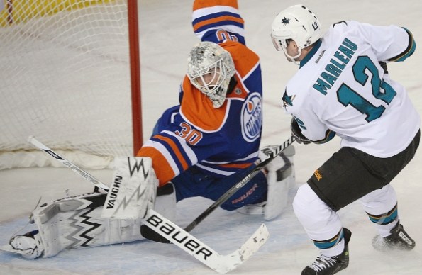 Ed Kaiser/Edmonton Journal Edmonton Oilers goaltender Ben Scrivens makes a breakaway save on San Jose Sharks forward Patrick Marleau during NHL action at Rexall Place in Edmonton last Wednesday. Scrivens set a new NHL-record with a 59-save shutout in Edmonton's 3-0 win.