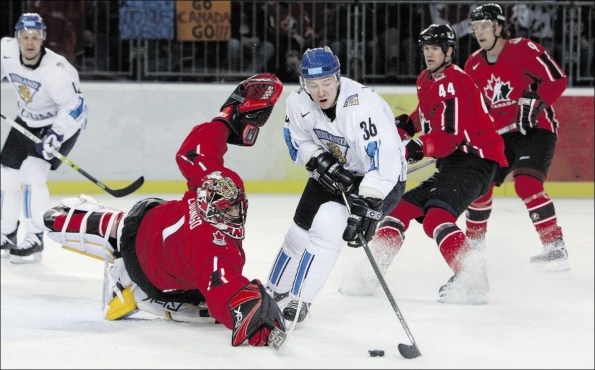 Getty Images file photo Jussi Jokinen of Finland skates around Team Canada goaltender Roberto Luongo at the 2006 Olympics in Turin, Italy, where the bigger ice surface caused problems for Canada en route to a seventh-place finish. Luongo and Jokinen will once again represent their respective countries in Sochi, but the other two Canadian players in this photo — defenceman Chris Pronger and winger Shane Doan — will not be participating.